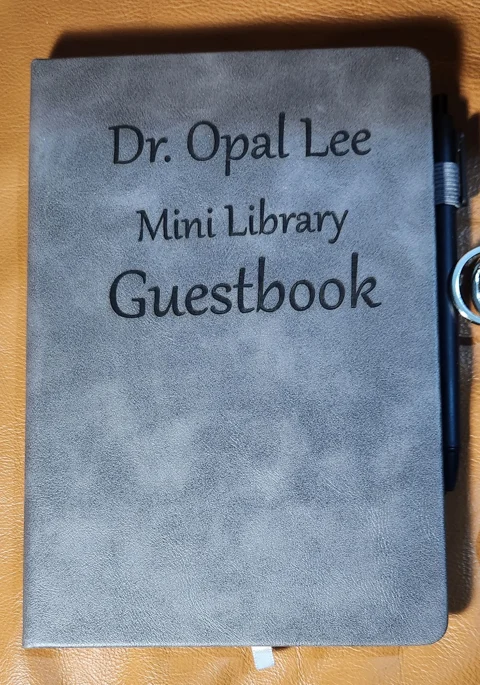 Open guestbook displaying printed pages created for visitors to the Dr. Opal Lee Little Free Libraries.