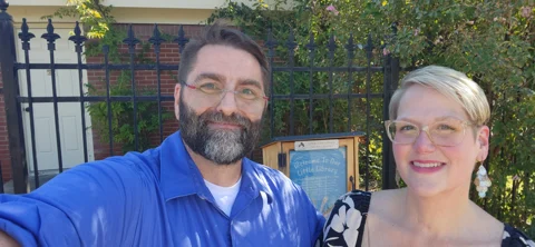 My wife and I standing in front of the Dr. Opal Lee Little Free Library dedicated to Dr. Lee and her belief that every child derves books.