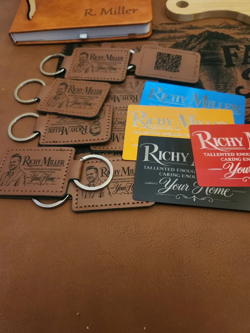 Custom leather realtor keychains engraved with Richy Miller's portrait and Your Home message, including QR-code keychains and matching colorful business cards.