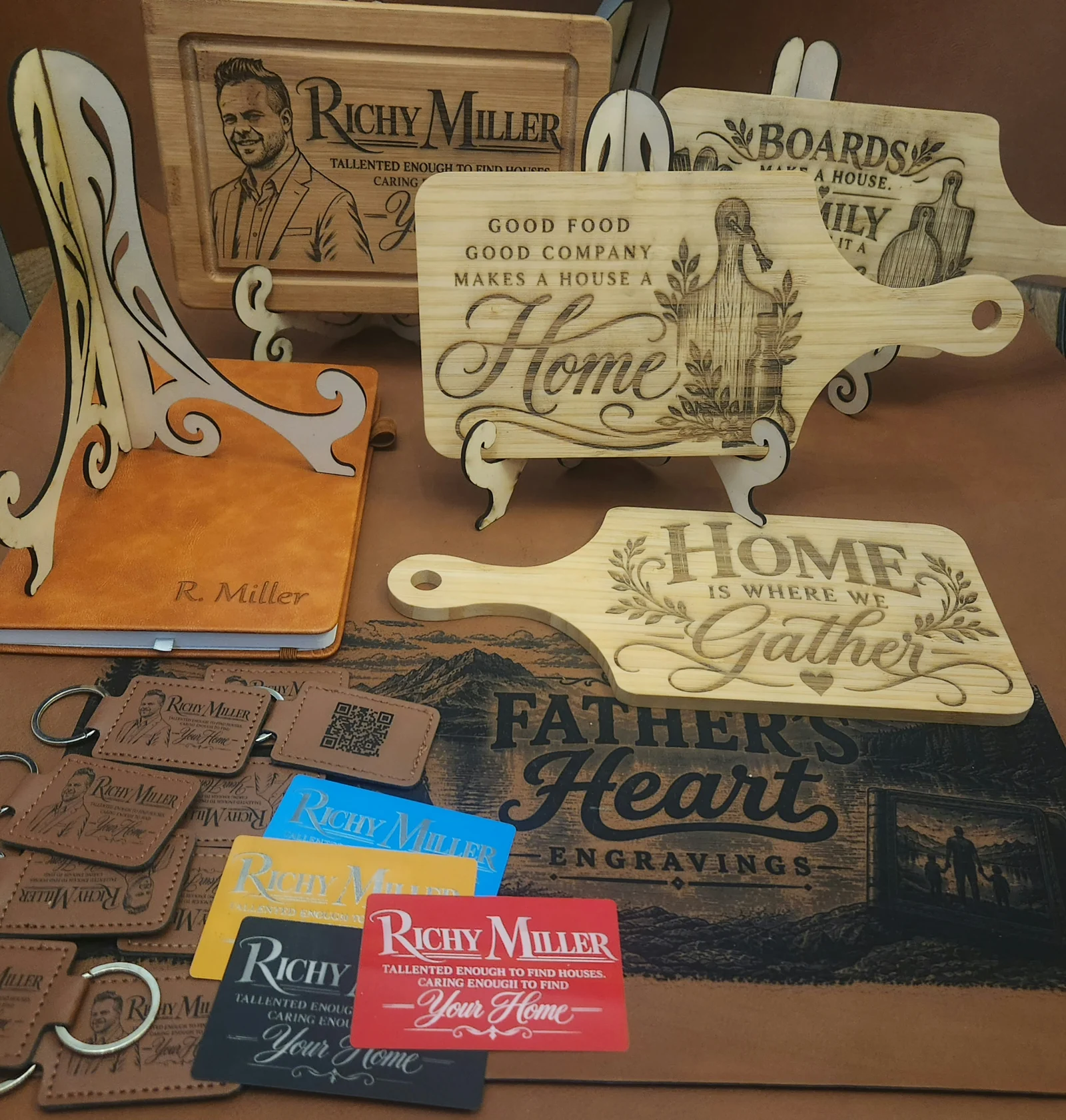 Collection of custom gifts and marketing pieces created for realtor Richy Miller, including engraved home-themed cutting boards, a portrait display board, personalized journal, leather QR-code keychains and business cards.